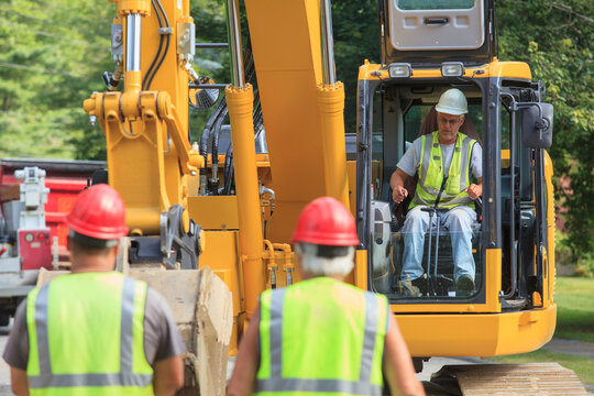 Heavy construction equipment operator in excavator