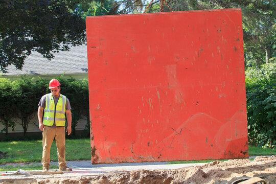 Construction worker standing beside shoring