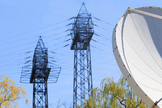 Satellite dish and power transmission towers