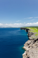 Fototapeta premium Coastal cliffs and deep blue ocean at Cape Zanpa in Okinawa, Japan 沖縄・残波岬の断崖と青い海の風景