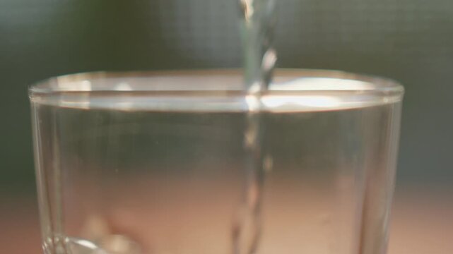 The slow-motion image of pouring clean water into a glass conveys the message of cleanliness and freshness.