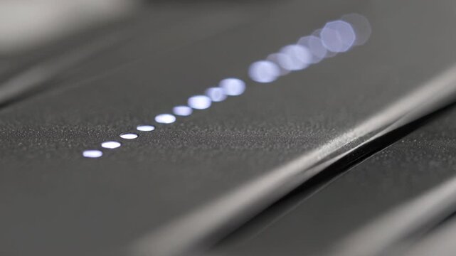 Close-up macro shot of textured dark metallic surface with small dots pattern