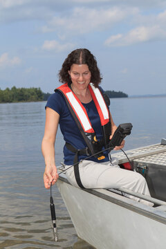 Water treatment engineer using electronic sensor to test water quality