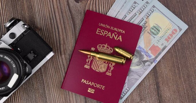 Putting money banknotes inside identity book for luxury holiday expenses presentation, illegal bribe graphics and personal savings budget clips.