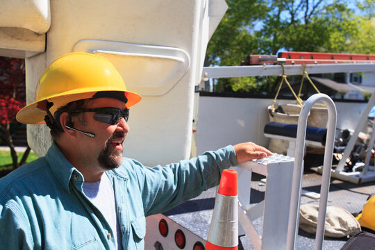 Power engineer with lift bucket truck to work on power lines