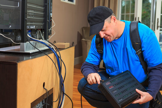 Service man connecting cable to modem box for home TV