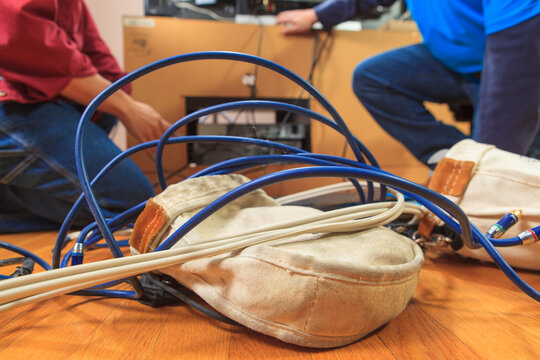 Cable installer showing home owner how to simplify cable routing