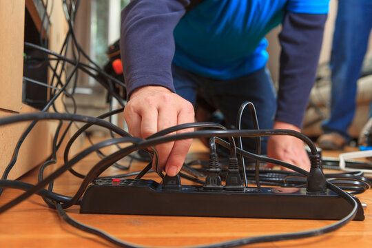 Cable installer putting plugs into power source