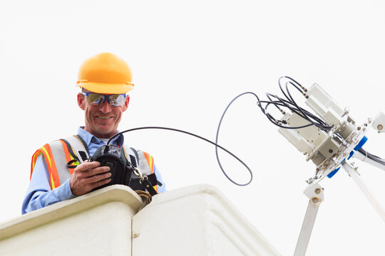 Communications engineer measuring signal level at low noise amplifiers and feedhorns at satellite