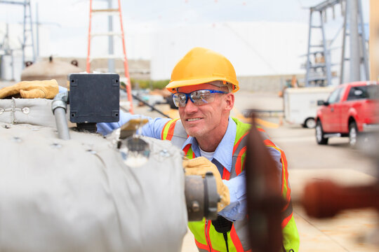 Electrical engineer examining pressure sensor at an electric power plant