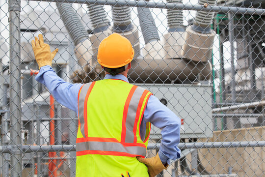 Electrical engineer examining transformers inside of an electric power plant