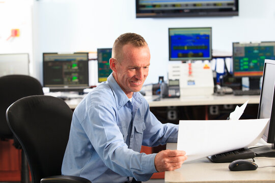 Electrical engineer in central operating command room at power station
