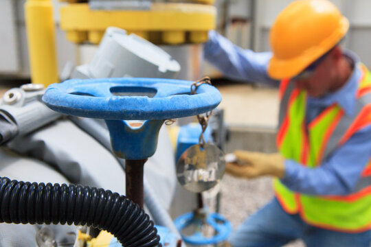 Engineer at electric power plant working with manual valves