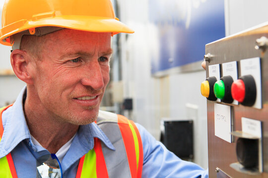Engineer at electric power plant examining carbon dioxide controls and indicators