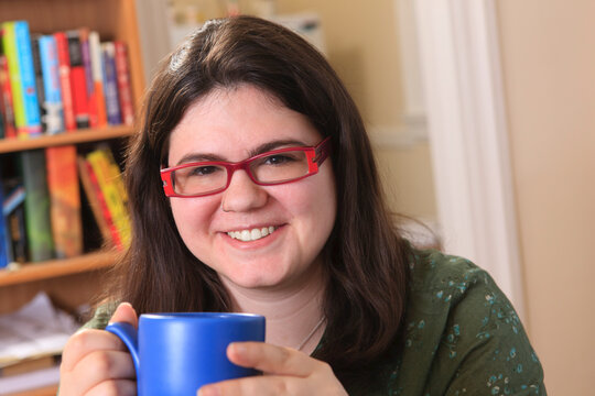 Woman with Asperger's syndrome relaxing with a mug of tea
