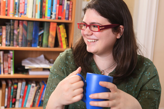 Woman with Asperger's syndrome relaxing with a mug of tea