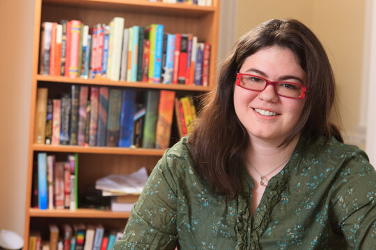 Portrait of a woman with Asperger syndrome and her books