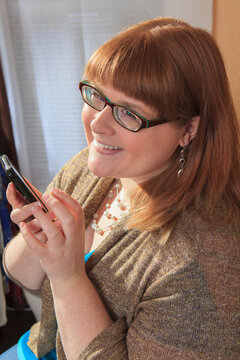 Woman who is legally blind using her smart phone