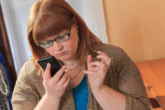 Woman who is legally blind showing frustration with her smart phone