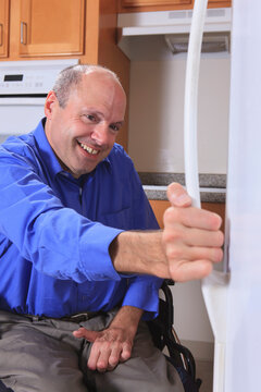 Man with Friedreich's Ataxia and deformed hands using his refrigerator