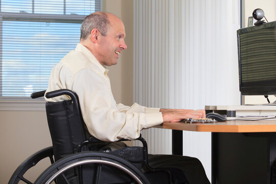 Man with Friedreich's Ataxia and deformed hands as an electronic design engineer at his workstation