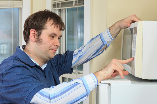 Man with Asperger's living in his home and cooking in microwave