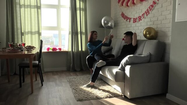 Mother plays with her son with a balloon