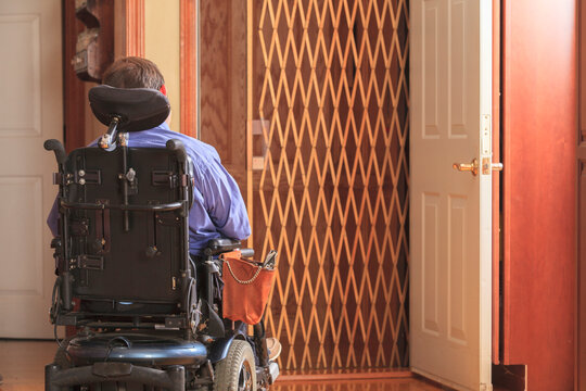 Man with Cerebral Palsy entering a home elevator