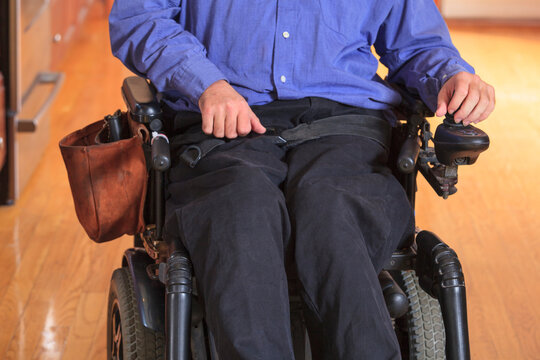 Man with Cerebral Palsy in his motorized wheelchair in his kitchen