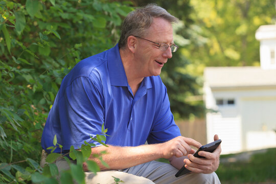 Man with Cerebral Palsy and dyslexia reading his tablet