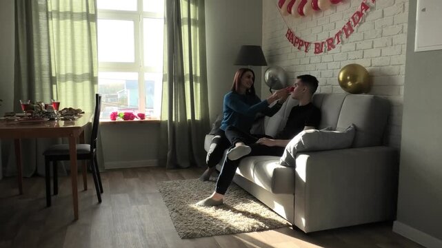 Mother and son having fun sitting on the sofa