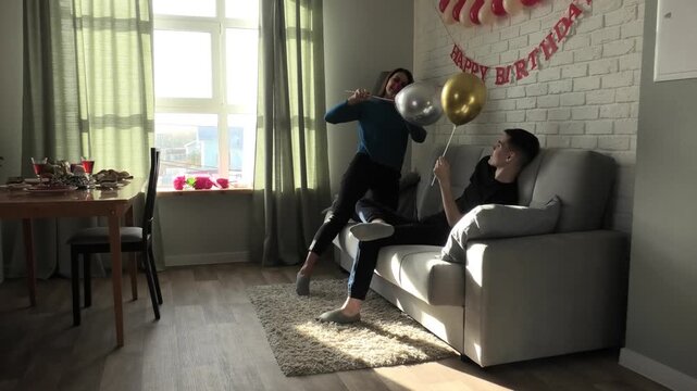 Mother and son fighting with balloons