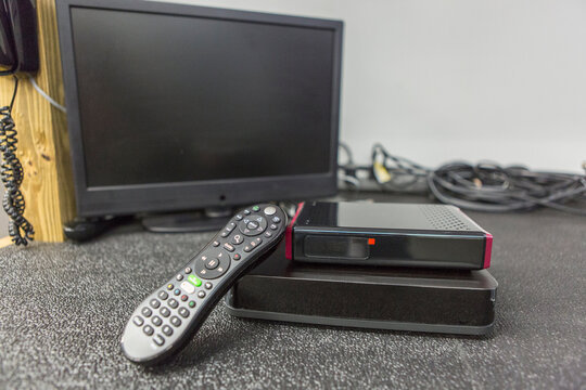 Close-up of cable modem, set top box and TV