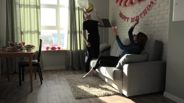 Mother and son throwing a balloon