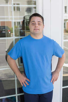 Man with Down Syndrome standing against window