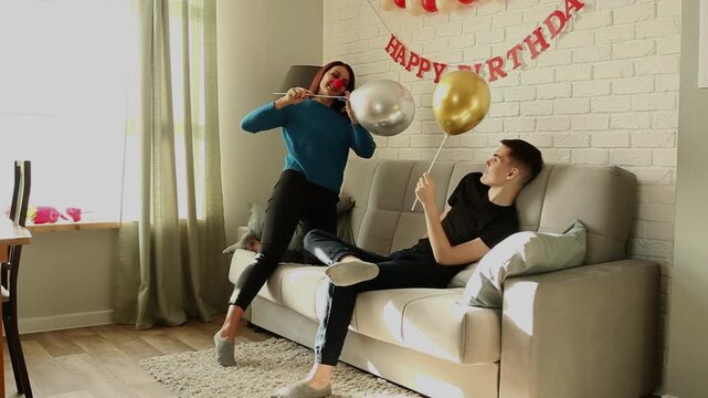 Mother and son fighting with balloons