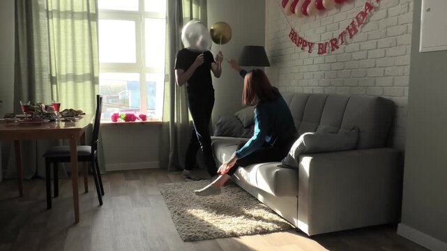 Mother and son fighting with pillows