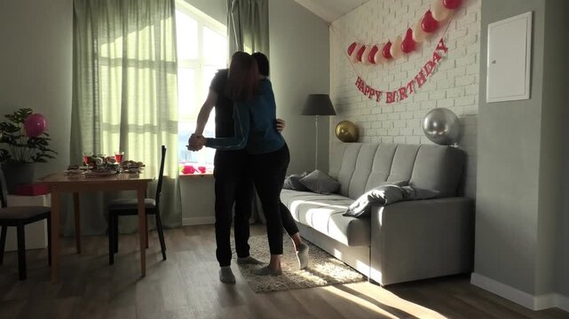 Mother and son getting ready to dance and hugging