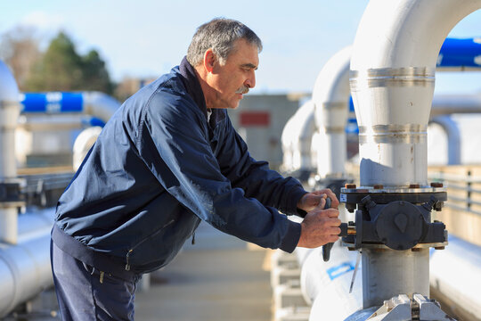 Engineer adjusting water flow control valve