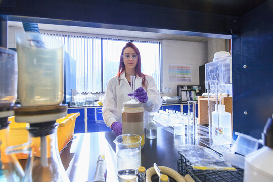 Lab chemist preparing graduated cylinder for standard solution
