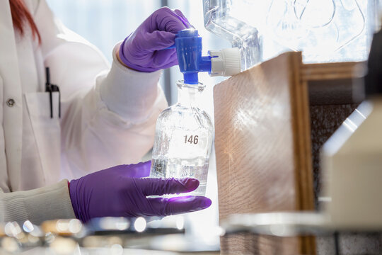 Lab chemist collecting reagent