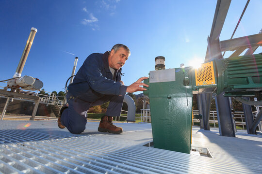 Engineer examining motor driven gate valve control