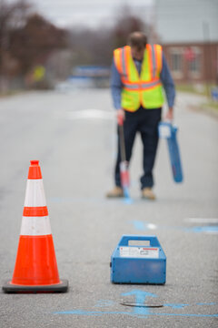 Water department technician marking underground location of water pipes