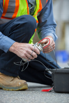 Water department technician using flow rate sensor