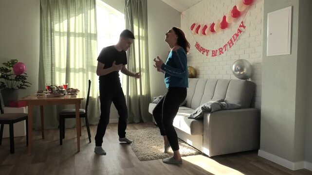 Mother and son dancing a fast dance