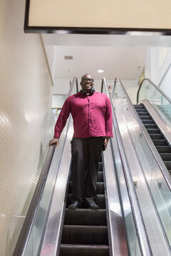 Man with ADHD standing on an escalator
