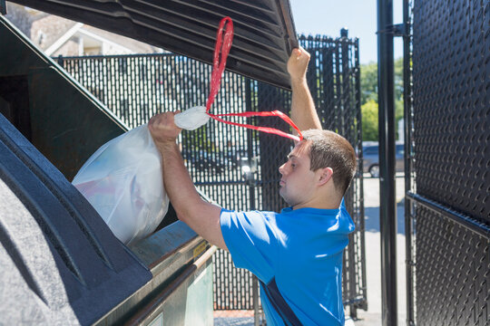Man with Down Syndrome throwing garbage
