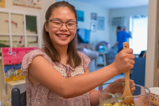 Teenage girl who has Learning Disability cooking