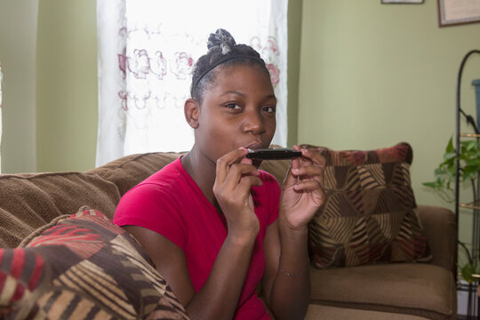Teen living with Bipolar Disorder playing the harmonica