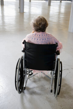 Rear view of an old woman sitting in the wheelchair - Staged